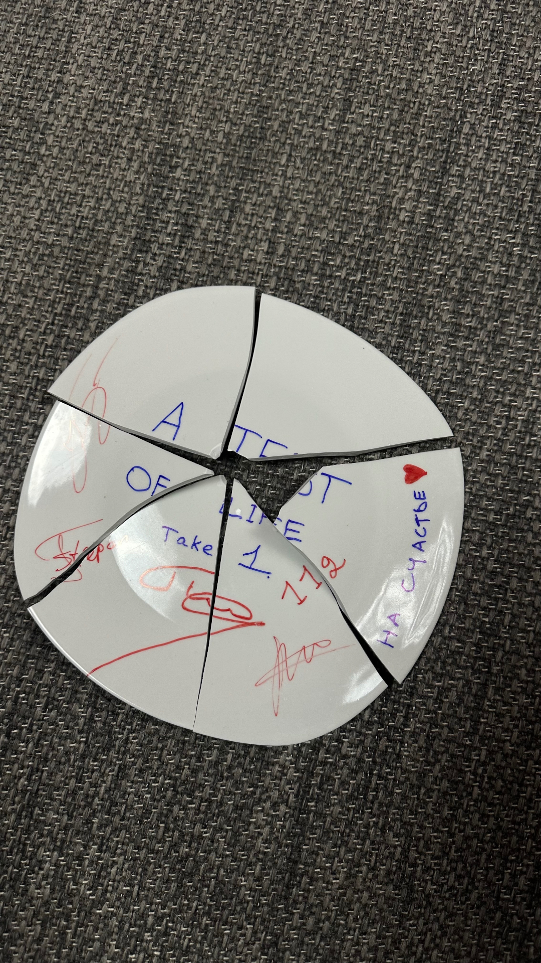 First-day prop: the plate signed by the crew